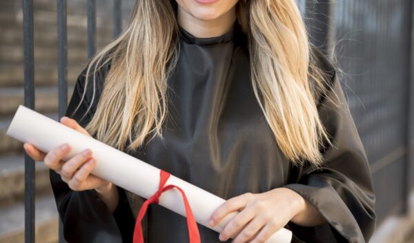 front-view-girl-smiling-holding-her-certificate[1]